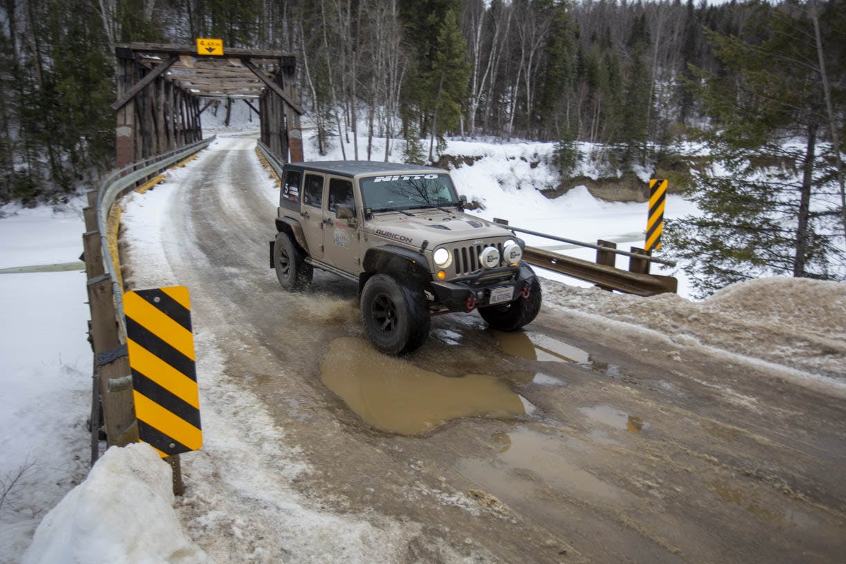 jeep wrangler front three-quarter action at alcan 5000 winter rally