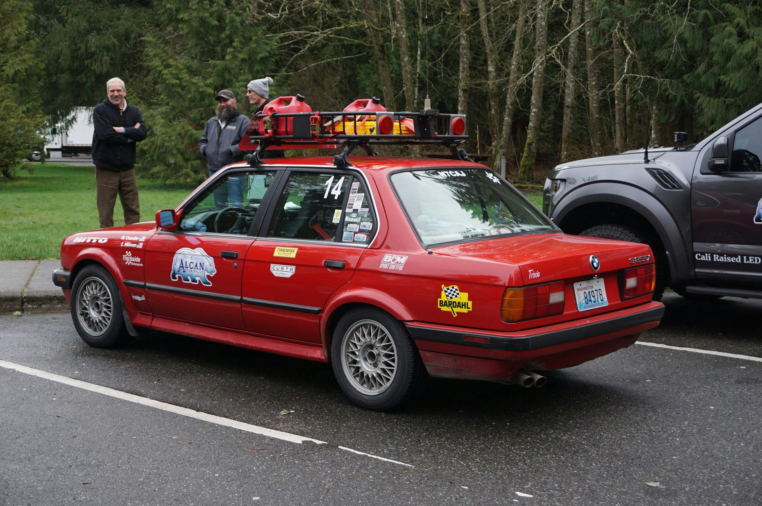 bmw rear three-quarter in parking lot for alcan 5000 rally