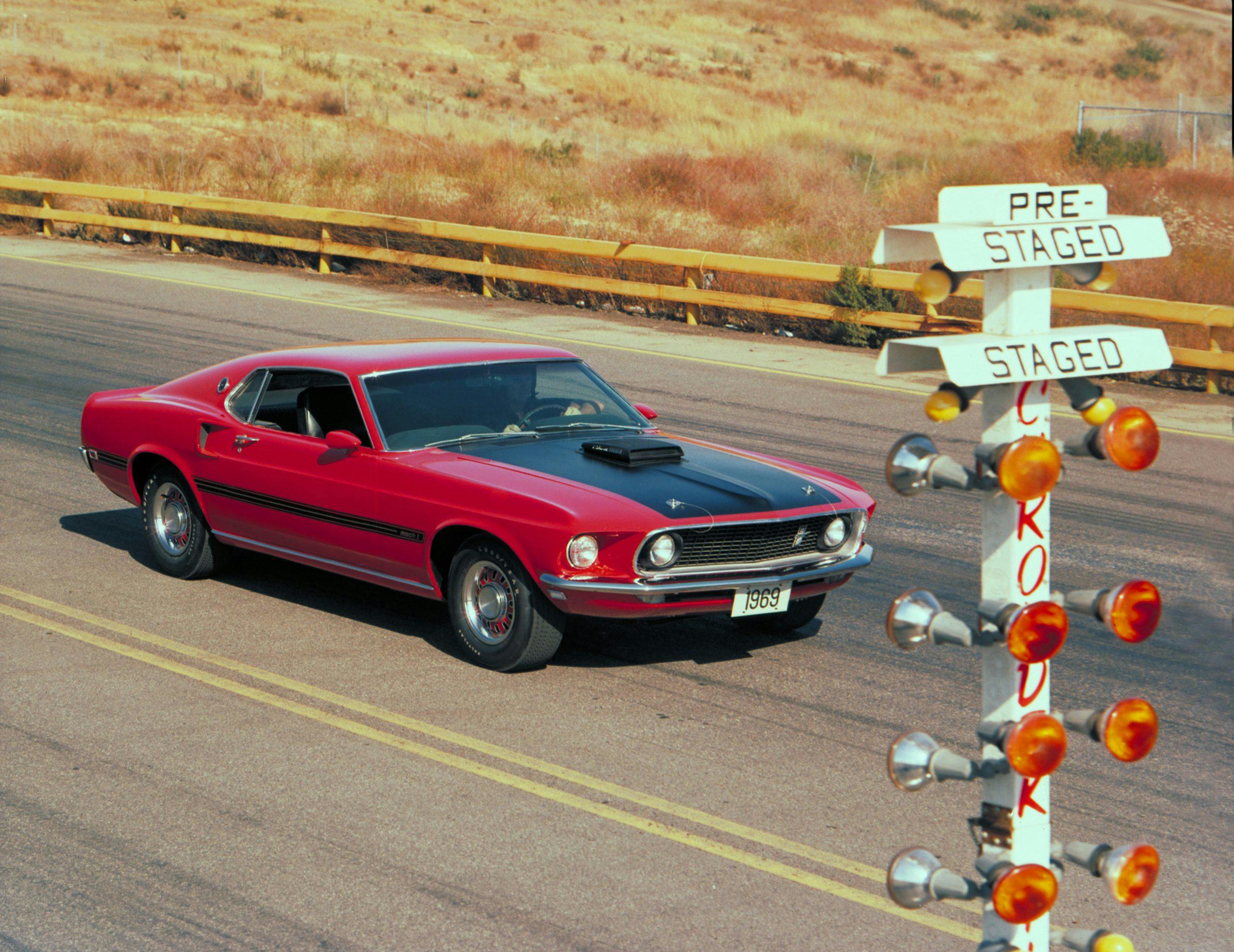 1969 Red Ford Mustang Mach 1 Fastback Front Three-Quarter At Track