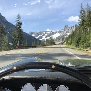 vintage maserati vignale spyder open road and snow capped mountain view