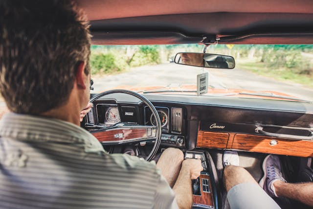 Father and Son Driving Camaro Interior