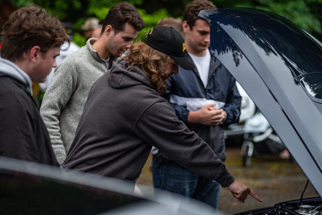 Teens Examine Engine Bay Under Open Hood