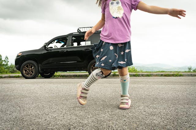 Girl Dances Before Toyota Land Cruiser