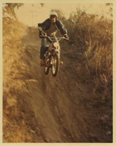 vintage photo of someone off-road on a motorcycle
