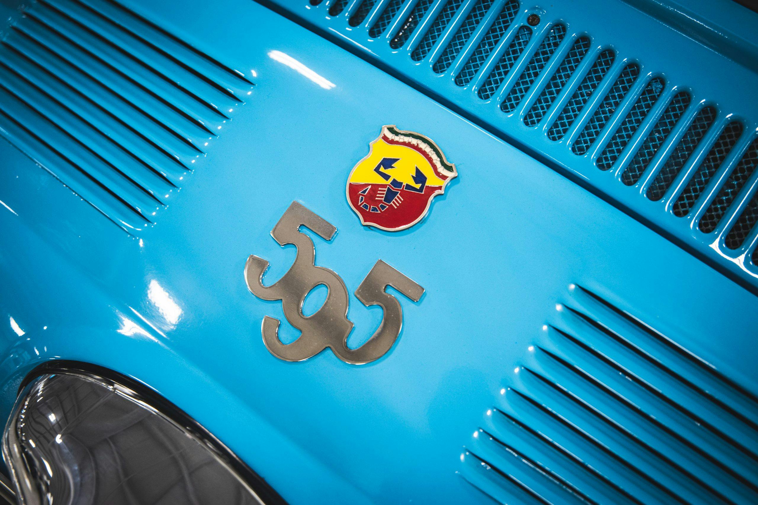 595 abarth emblem on blue