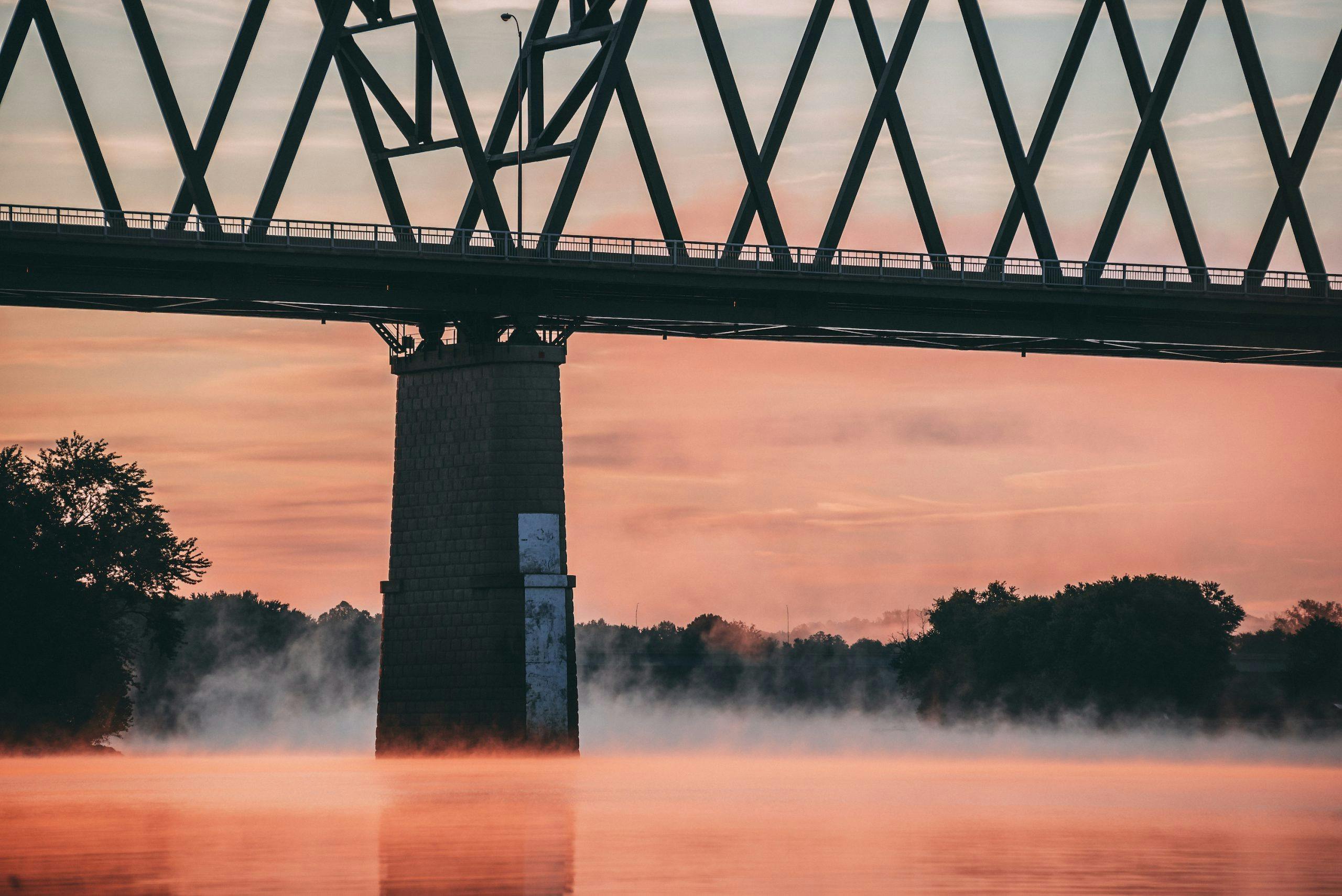 Foggy Ohio River Train Bridge At Pink Sunset