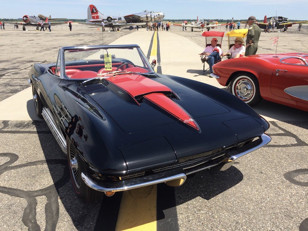 vintage black corvette convertible front three-quarter at airstrip