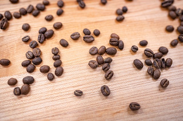 whole coffee beans on wood table close up