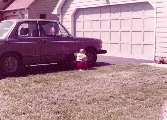 baby sam smith beside bmw 2002 in driveway