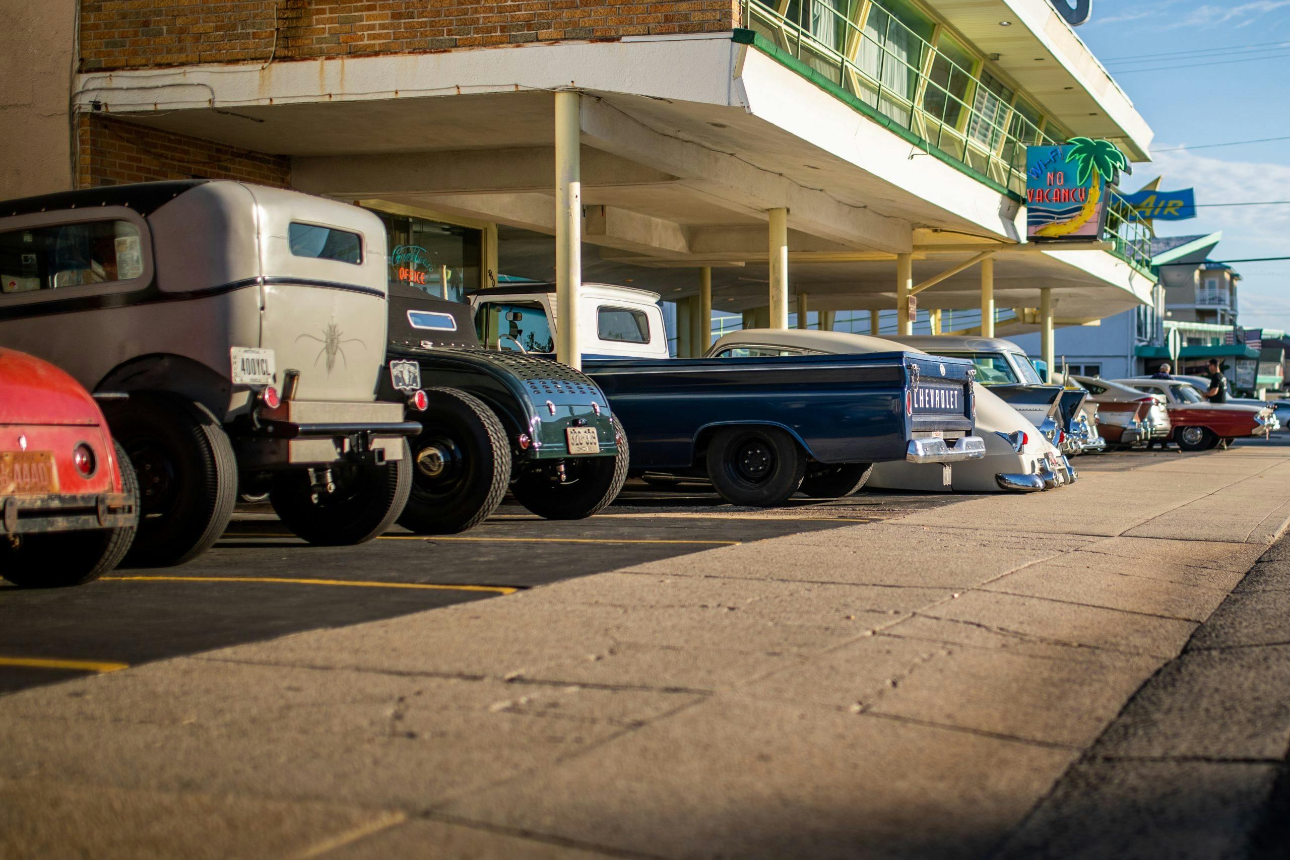 hot rods lined up under motel