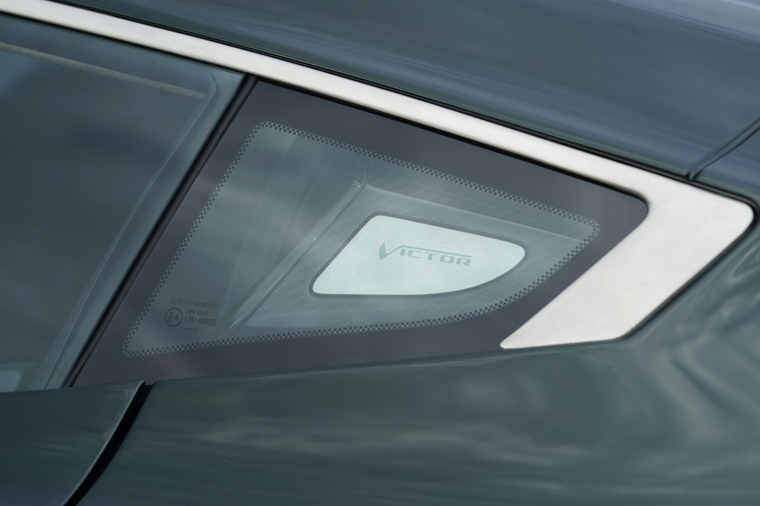 Aston Martin Victor glass panel type logo detail