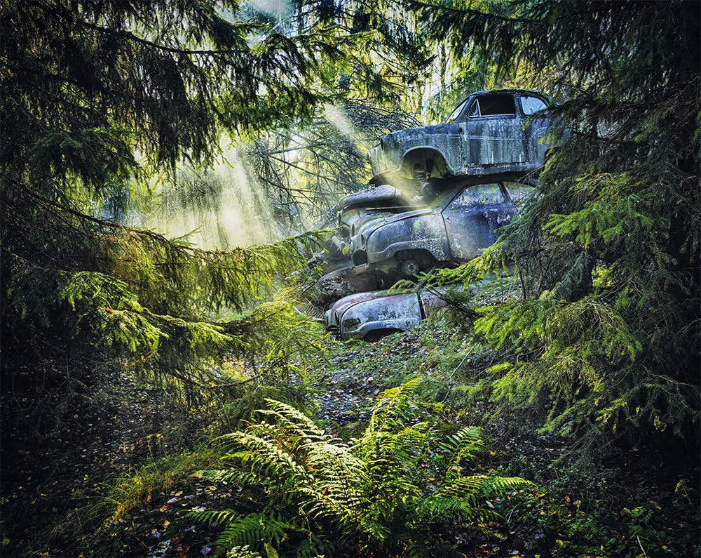 saab austin stack pile cars in mossy swedish forest