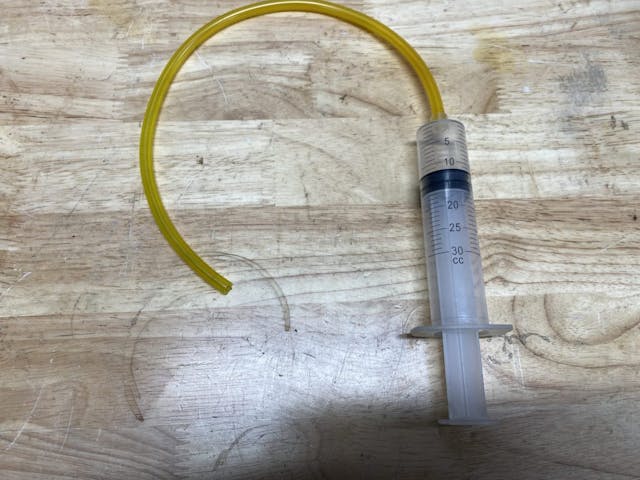 Syringe for brake bleeding