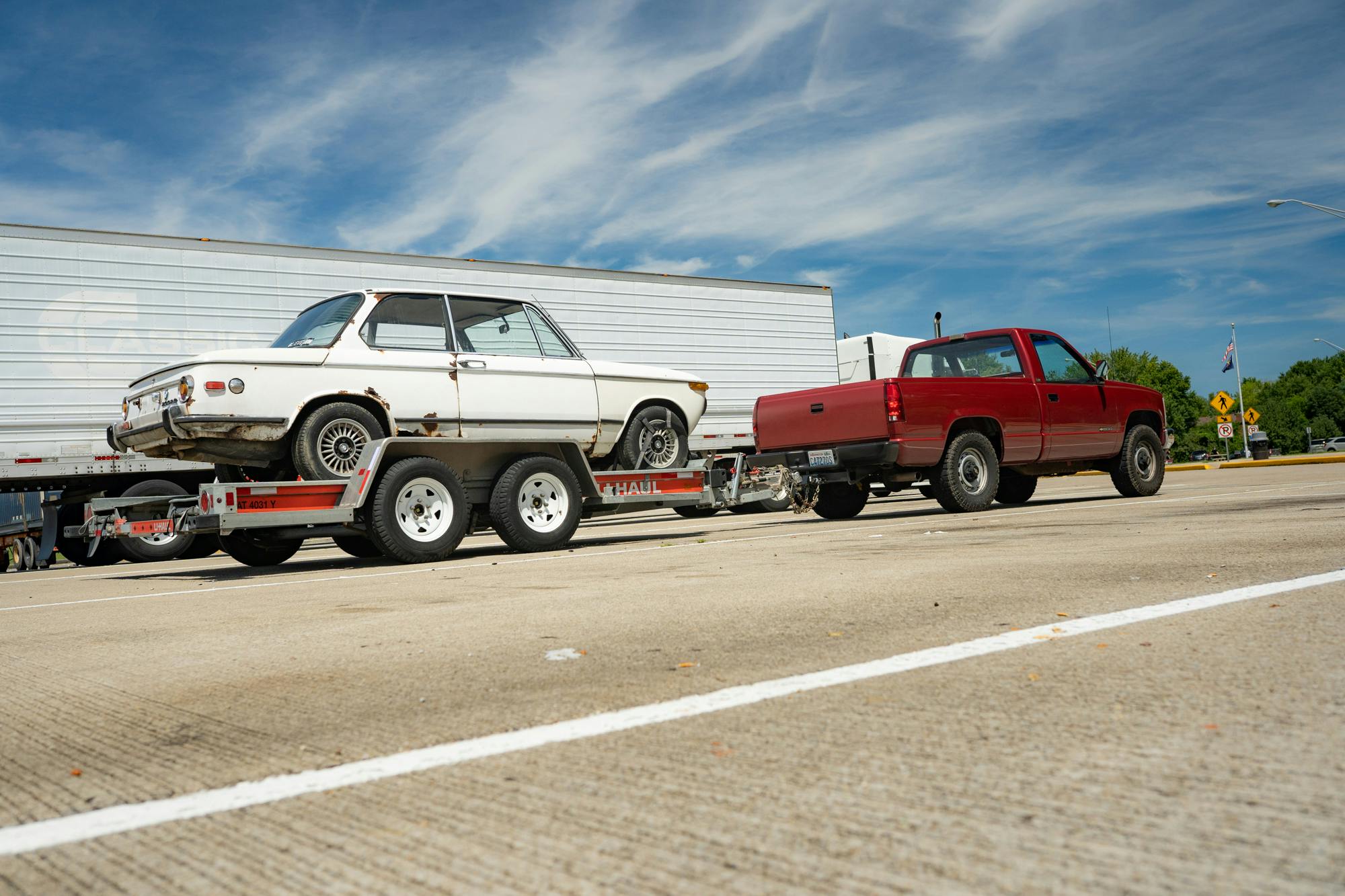 loaded bmw 2002 project car behind chevrolet silverado cheyenne