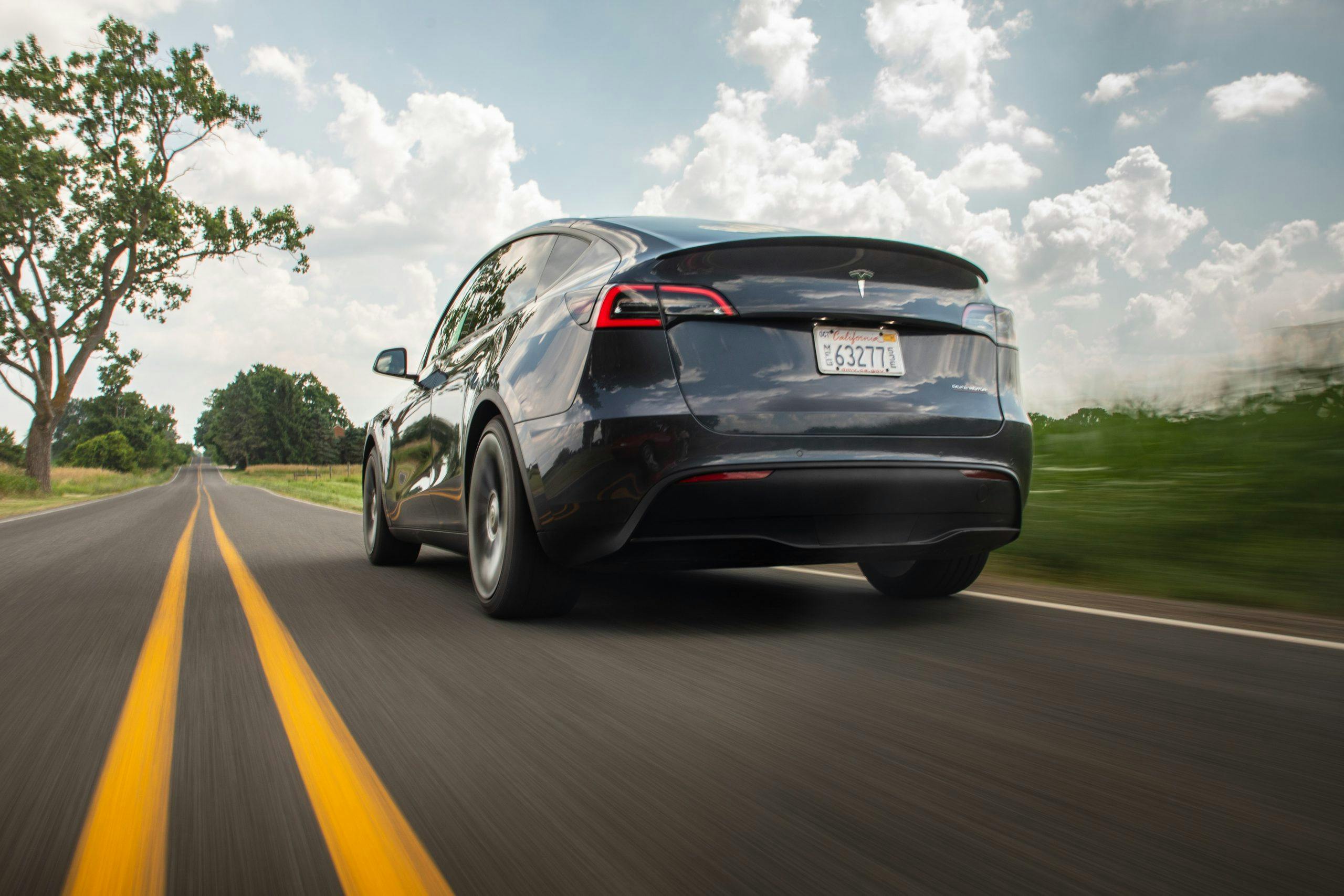 Tesla Model Y rear three-quarter dynamic road action