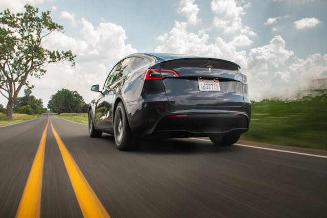 Tesla Model Y rear three-quarter dynamic road action year