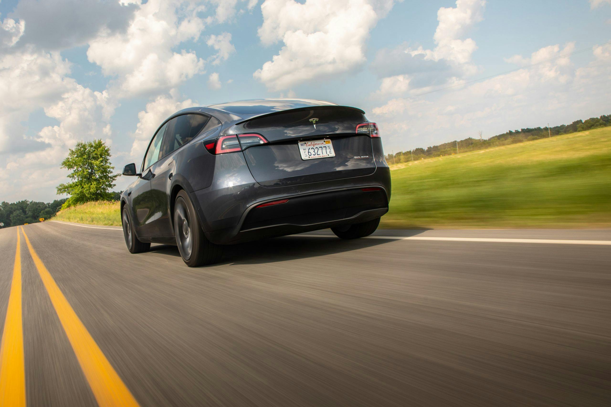 Tesla Model Y rear three-quarter dynamic road action