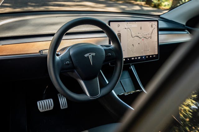 Tesla Model Y interior wheel and infotainment screen detail