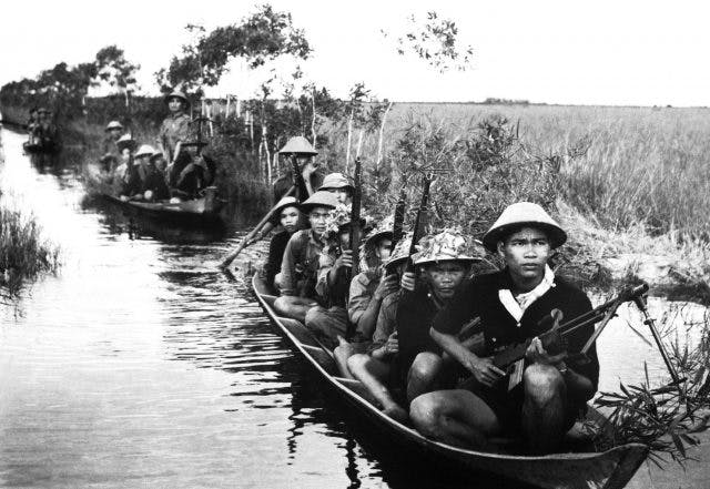 armed viet cong fighters in boats