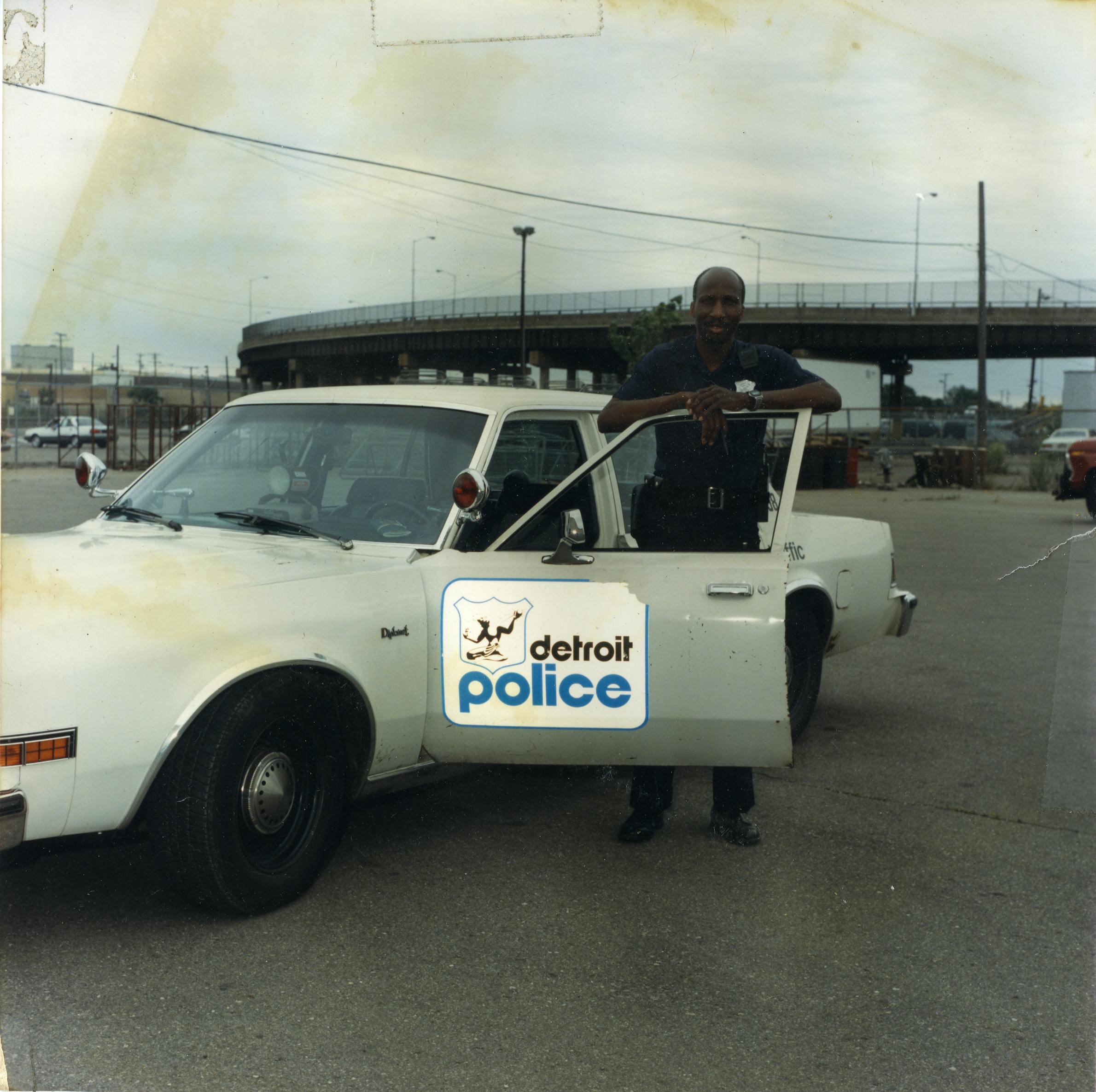 detroit soldier godfrey qualls in police uniform with retro squad car