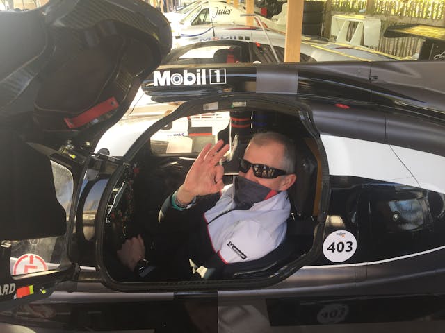 Coor sitting inside cockpit of racecar at goodwood