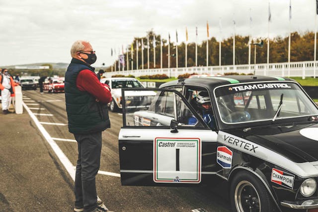 Philip Venables standing beside vintage bmw racecar