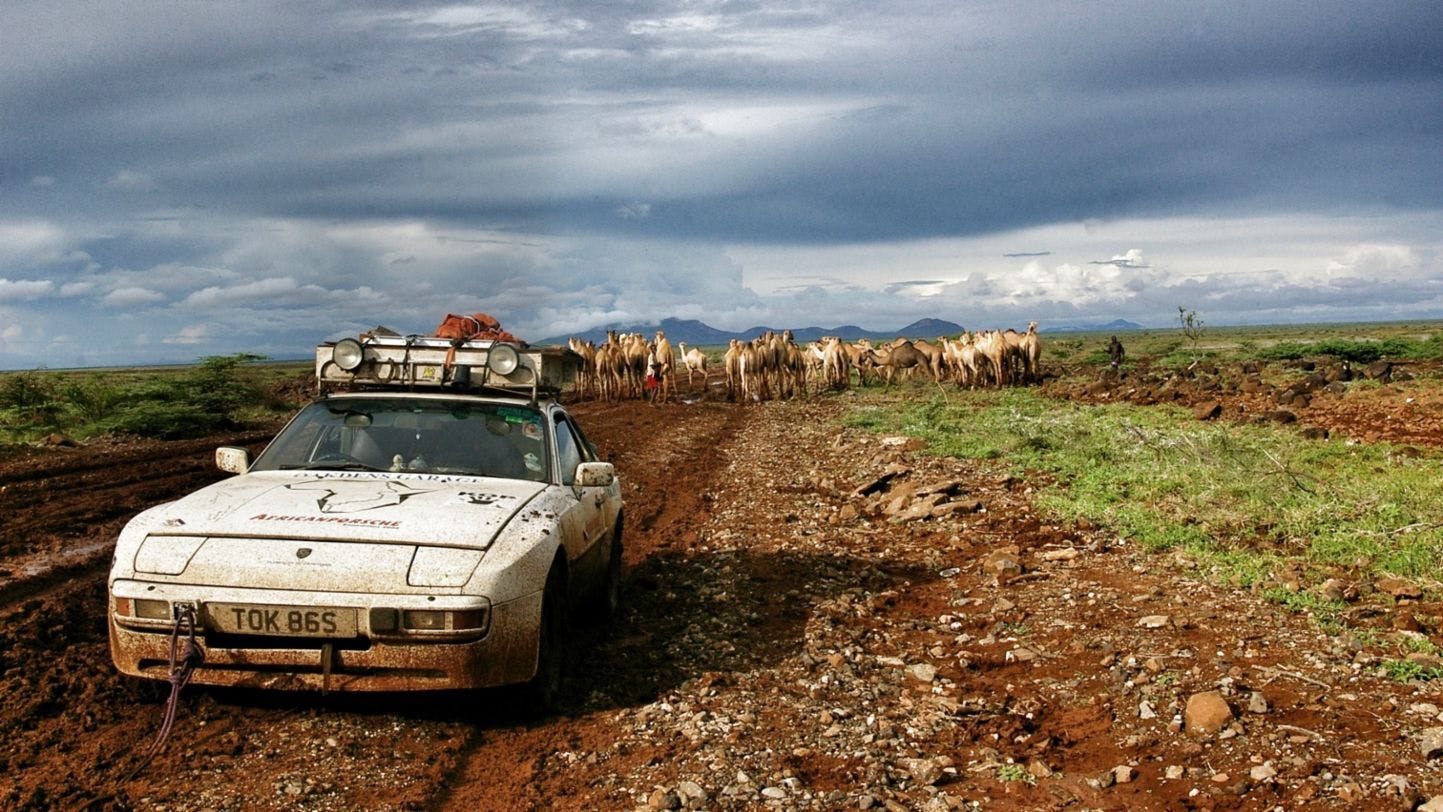 Africa Porsche 944 mud, camels, and car