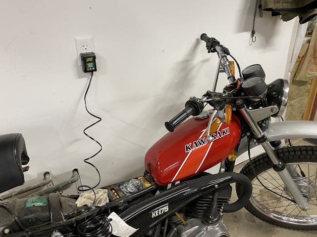Battery Tender on motorcycle storage garage