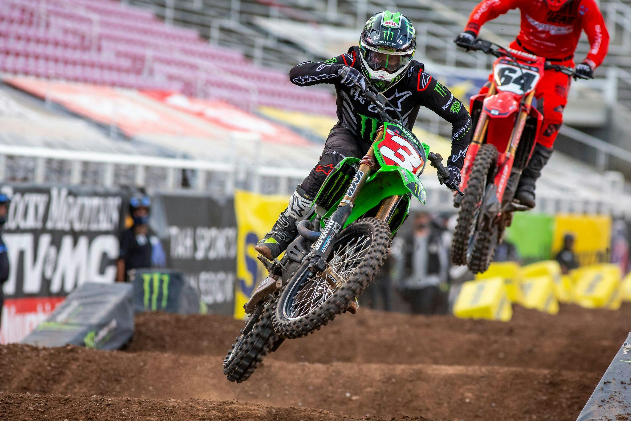 Supercross riders over jump section action