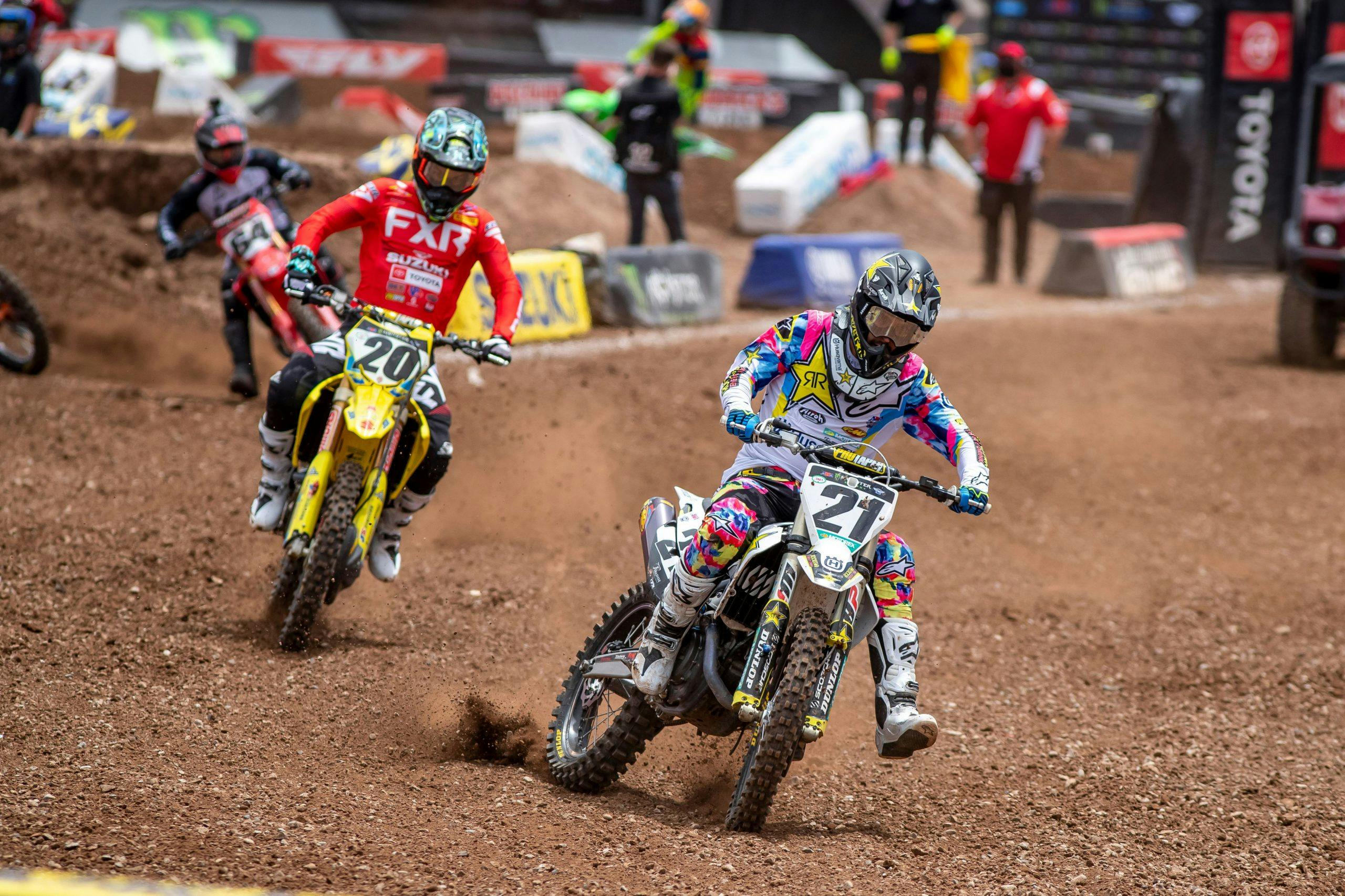 Supercross riders skidding on track action