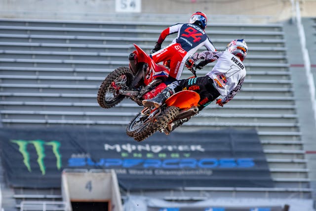 Supercross bike riders airborne action