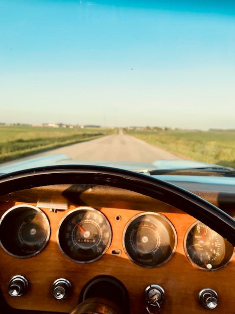 GTO convertible gauges down open road