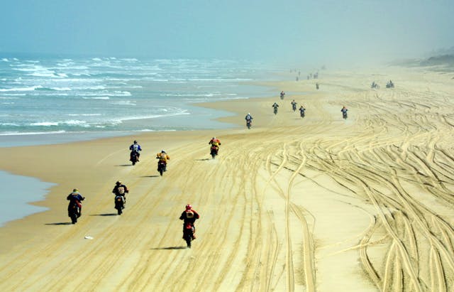 Motorcyclists Dakar rally beach last leg start