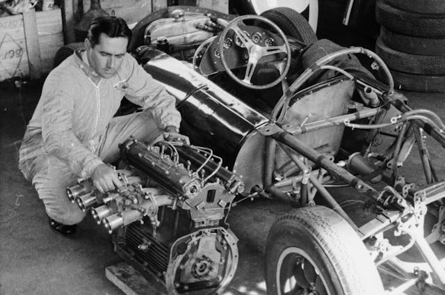 Jack Brabham inspecting engine
