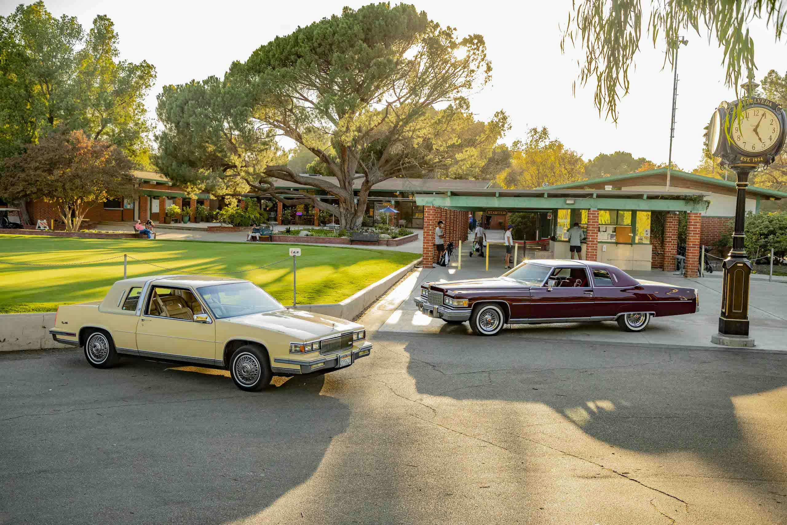 Cadillac Coupe DeVille 1976 and 1986 parked golf course