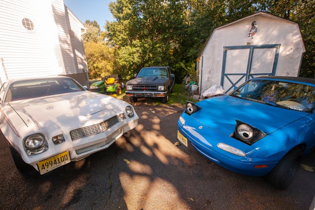 mazda and chevrolet collector cars in driveway