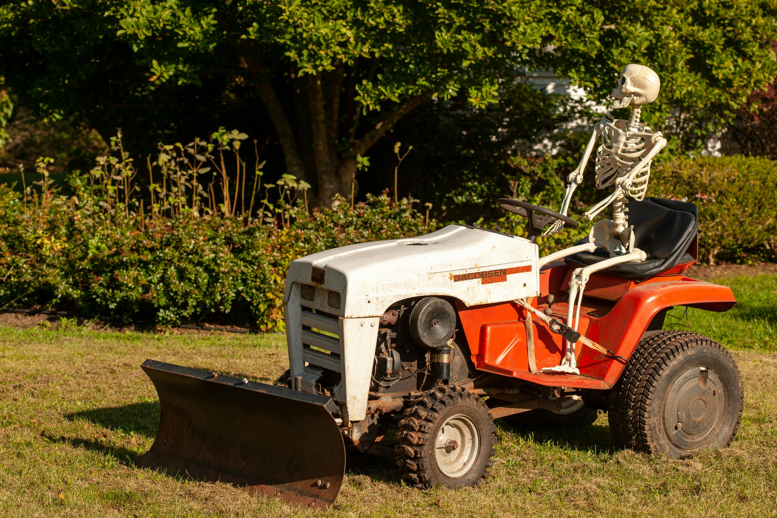 skeleton bones on riding lawn tractor front three-quarter