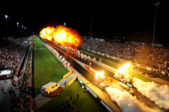 IHRA drag car take off action fire and smoke run aerial view