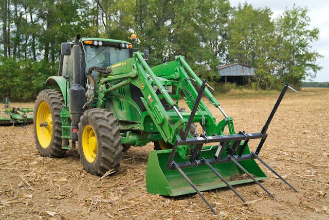 John Deere Tractor with bushhog attachment on front loader