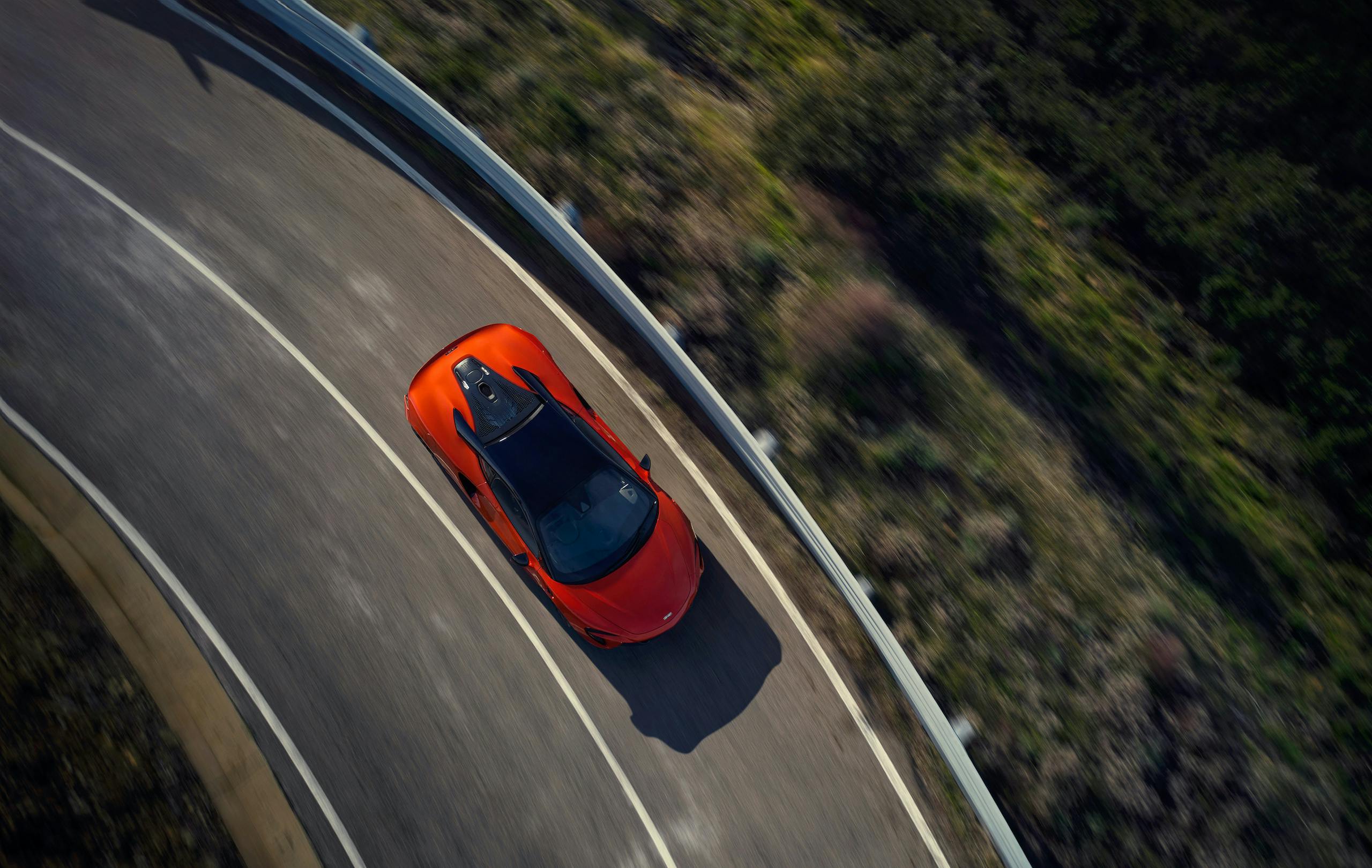 McLaren Artura orange overhead dynamic road action