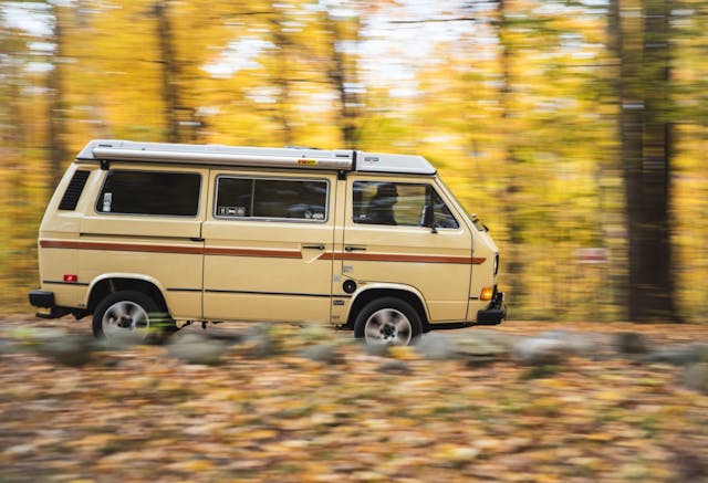 VW Vanagon driving in the woods