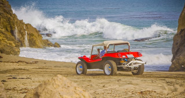 Meyers Manx Dune Buggy rear three-quarter on beach bruce at wheel