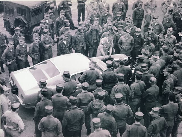 Lawman Boss 429 Ford Mustang historical military men at base surrounding car