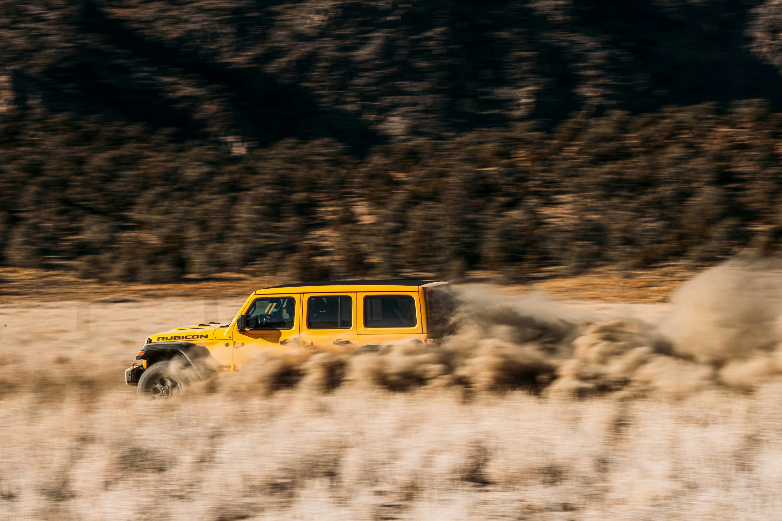 jeep wrangler rubicon off-road trail dust dynamic action
