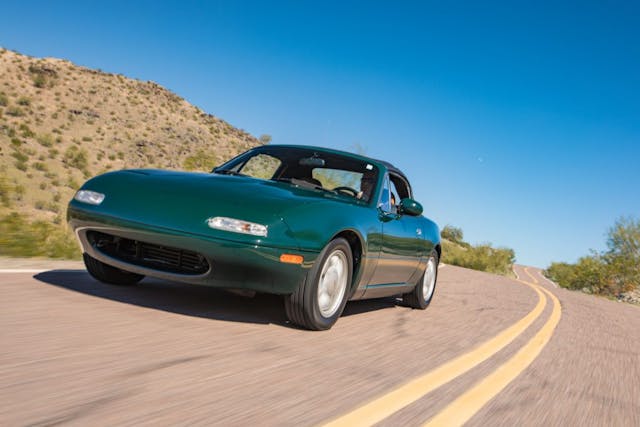 green mazda na miata driving action in desert