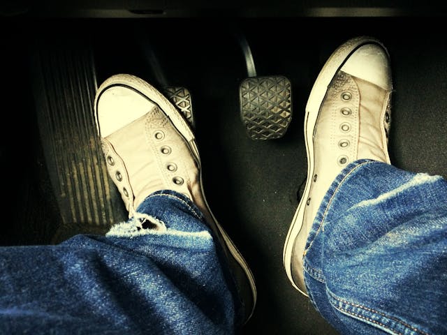 Human foot with pedals in car