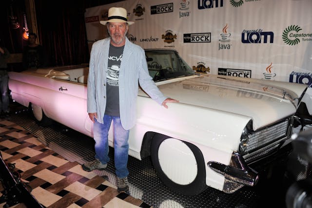 Neil Young poses with his electrified Lincoln Continental