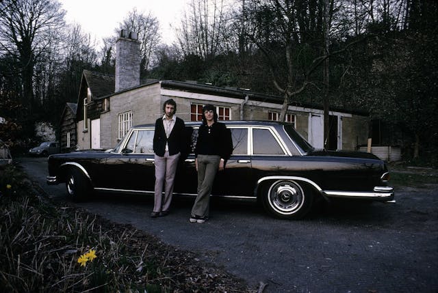Pete Townshend with fellow musician Rod Houison, at home in Goring on Thames next to his Mercedes limousine.