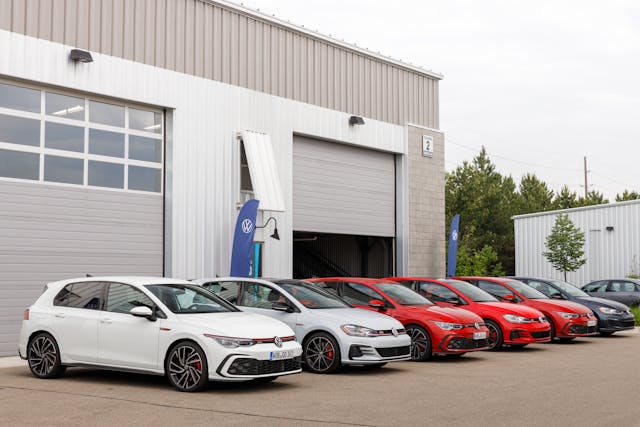 line of 2022 Volkswagen GTI in front of a garage