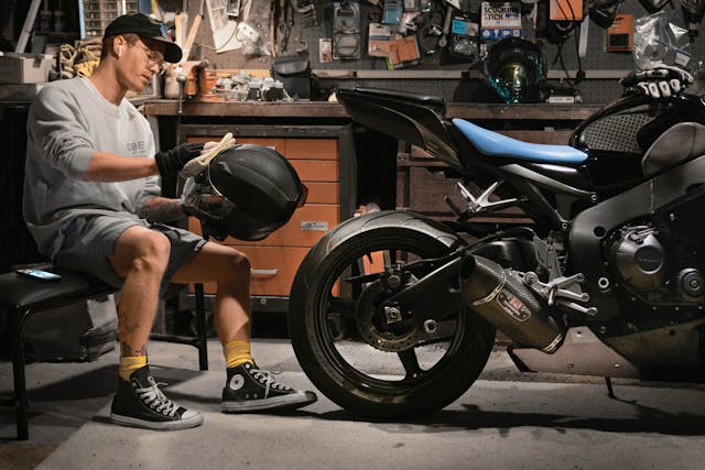 CBR 1000rr rider cleans helmet in garage